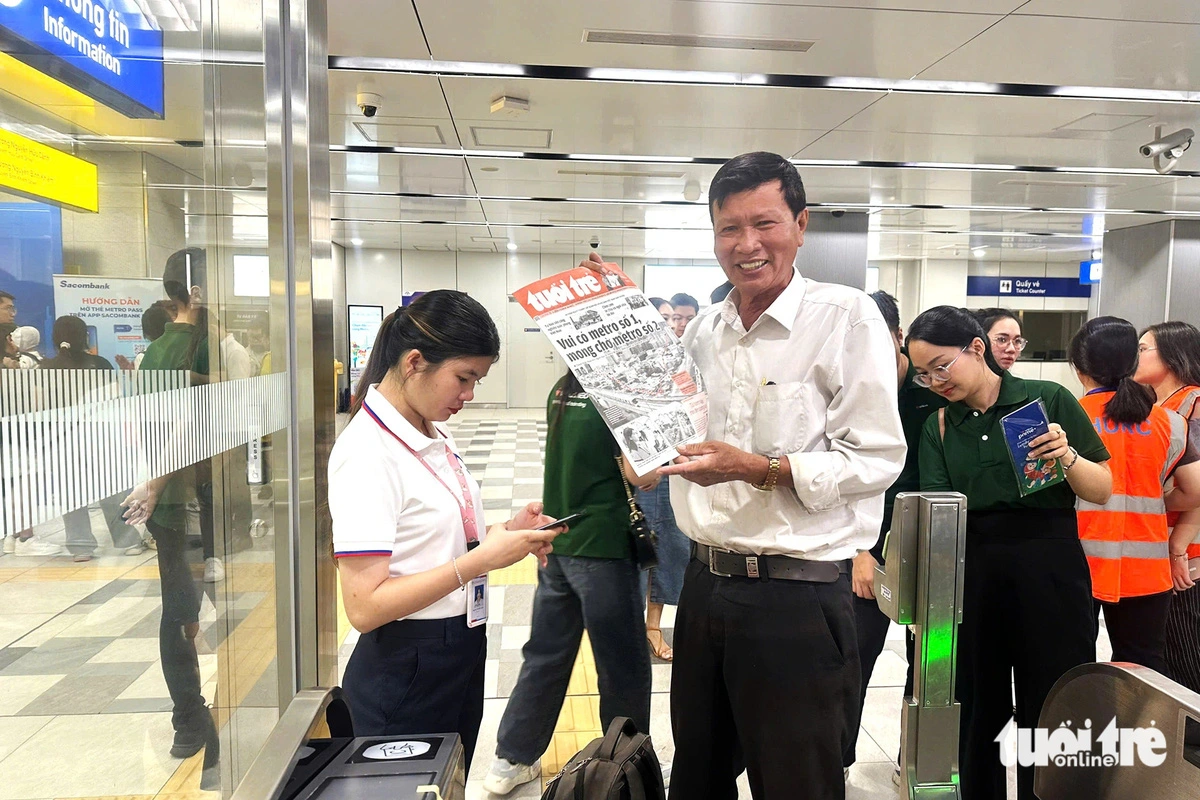 A man shows a Tuoi Tre newspaper copy at Ba Son Station before a trip on Ho Chi Minh City’s metro line No. 1, which started official operations on December 22, 2024. Photo: Huu Hanh / Tuoi Tre