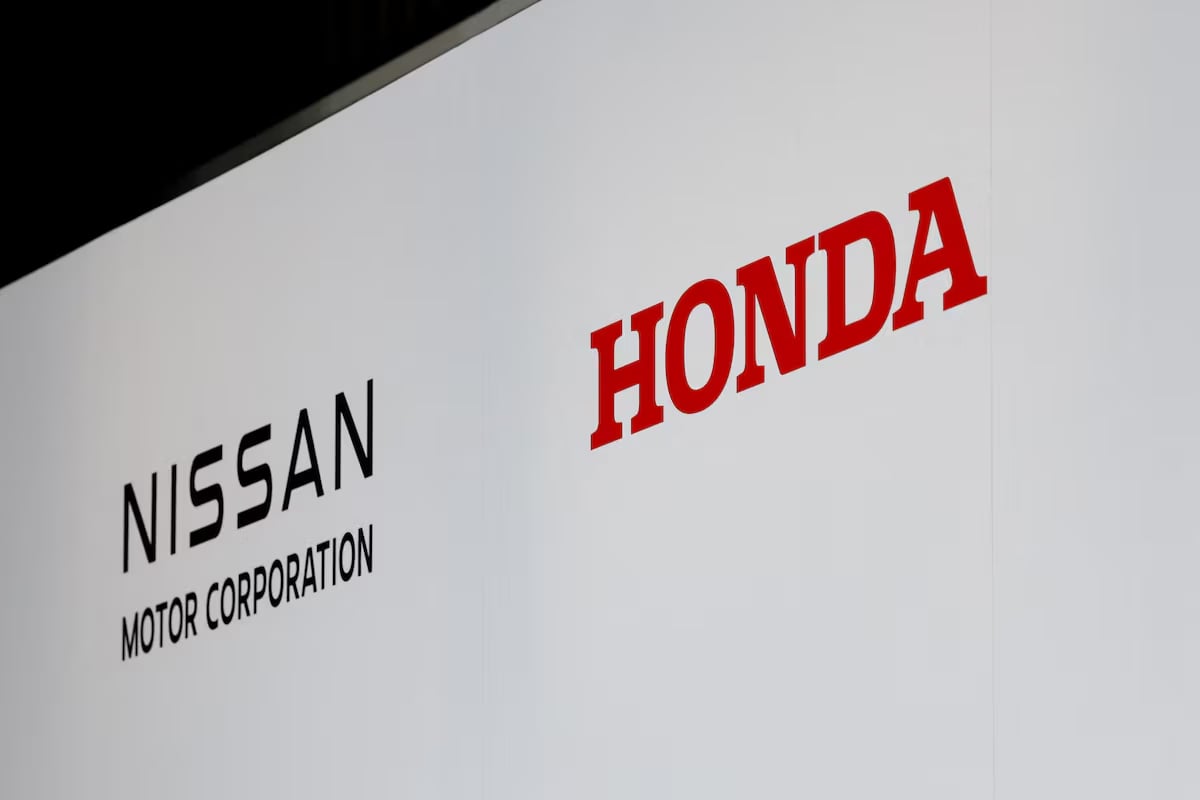 Logos of Nissan Motor Corporation and Honda are seen at a joint press conference on their merger talks, in Tokyo, Japan, December 23, 2024. Photo: Reuters