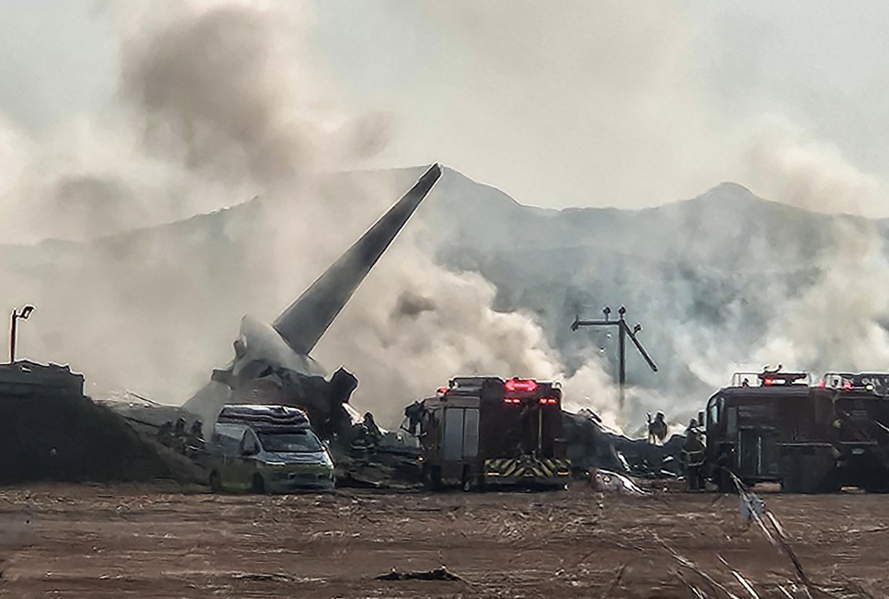 Firefighters carry out extinguishing operations on an aircraft which drove off runaway at Muan International Airport in Muan, South Jeolla Province, South Korea, December 29, 2024. Photo: Reuters