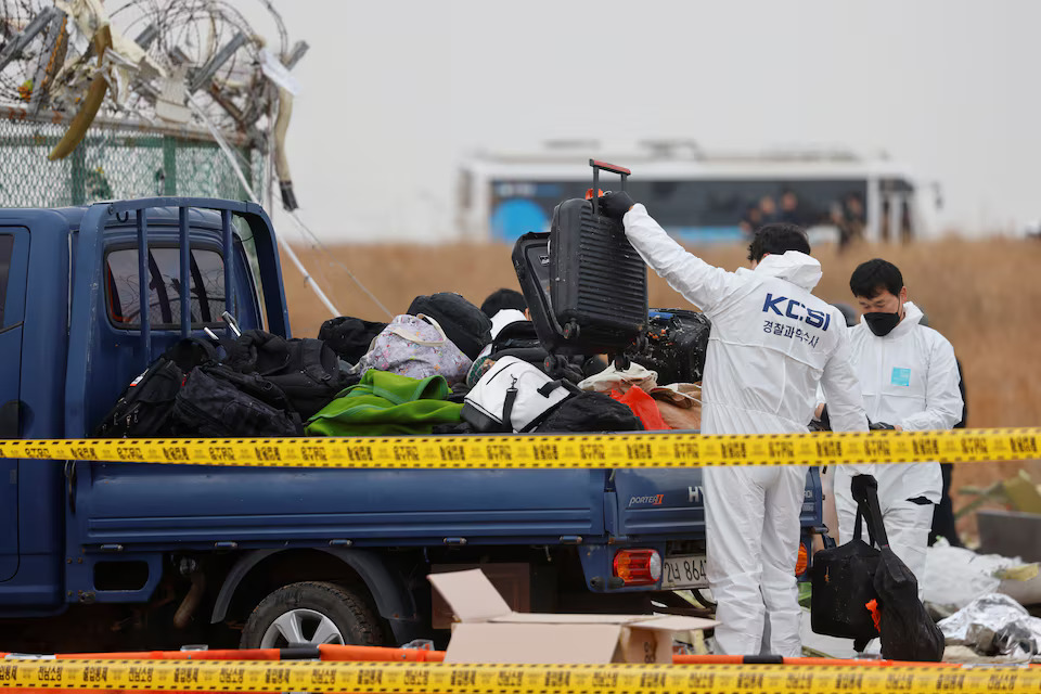 [8/11]People work at the site where an aircraft went off the runway and crashed at Muan International Airport, in Muan, South Korea, December 30, 2024. Photo: Reuters