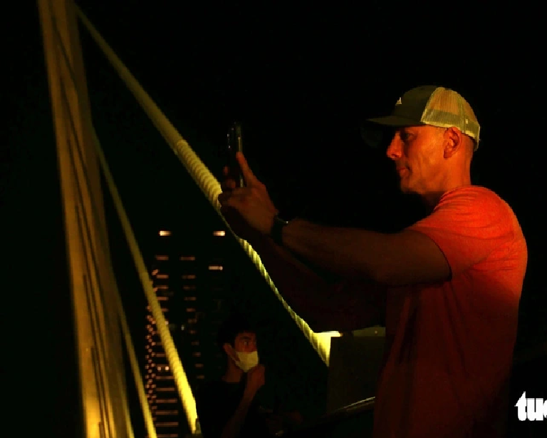 Thomas from Poland takes photos of the Ba Son Bridge in Ho Chi Minh City while walking on it. Photo: Bui Nhi / Tuoi Tre