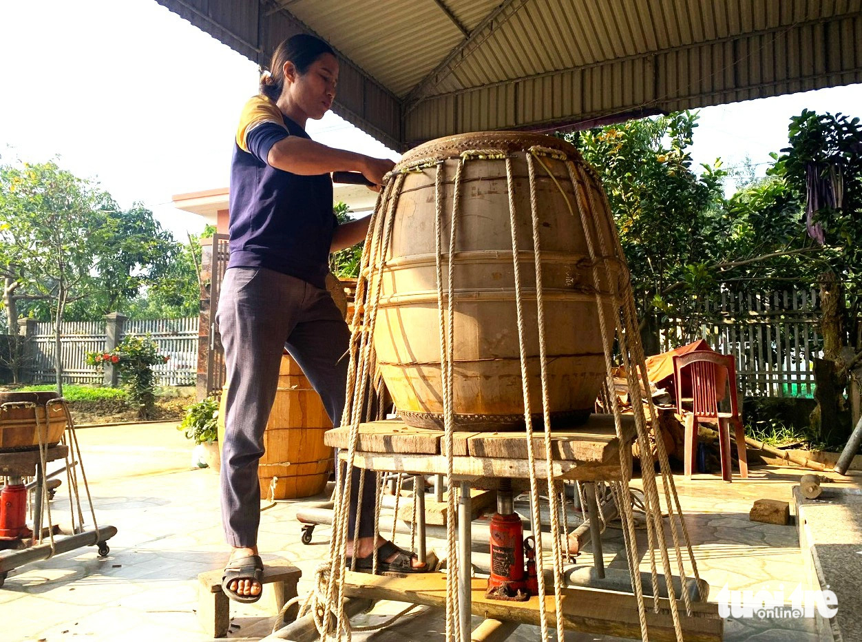 Nguyen Thi Binh finishes a drum for delivery to a customer in Bac Thai Drum Village, Thach Hoi Commune, Ha Tinh City, Ha Tinh Province, north-central Vietnam. Photo: Le Minh