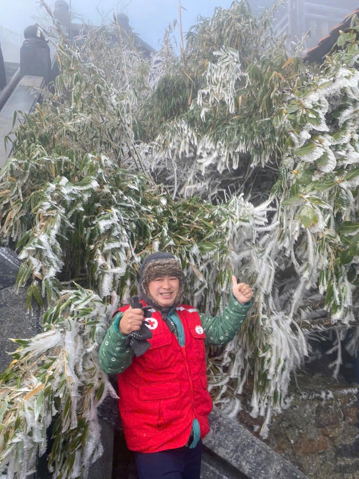 A tourist poses for a photo amid frost-covered trees on the summit of Fansipan, Vietnam’s highest peak, in Sa Pa Town, Lao Cai Province, northern Vietnam. Photo: Supplied