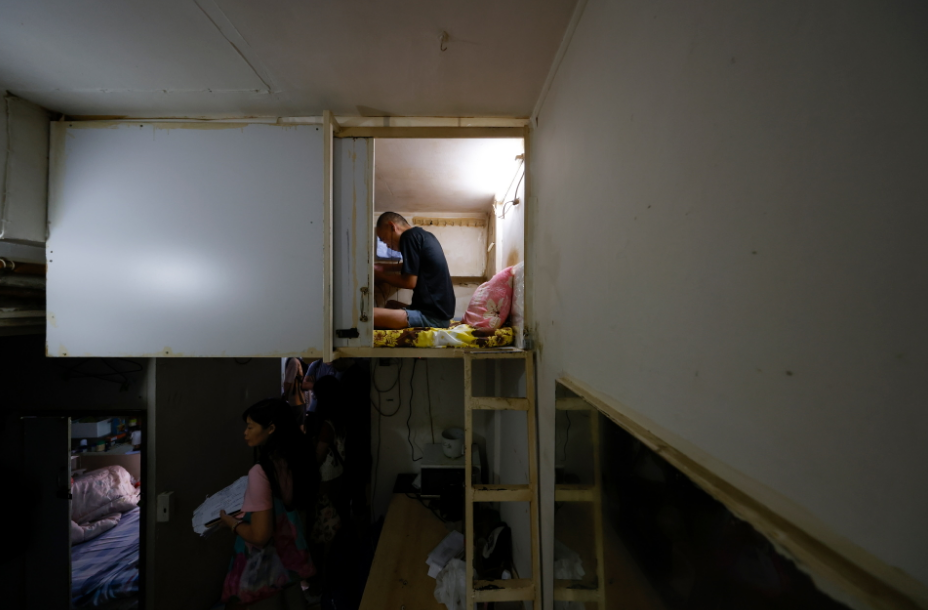 A resident rests in his upper-level 'coffin' home in Hong Kong, China, August 15, 2024. Photo: Reuters