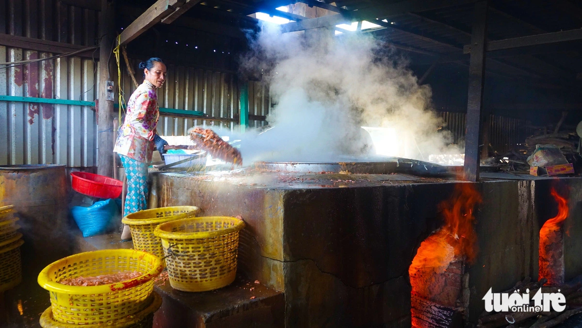 A woman boils shrimp before drying them in Phu Quoc City. Photo: Chi Cong / Tuoi Tre