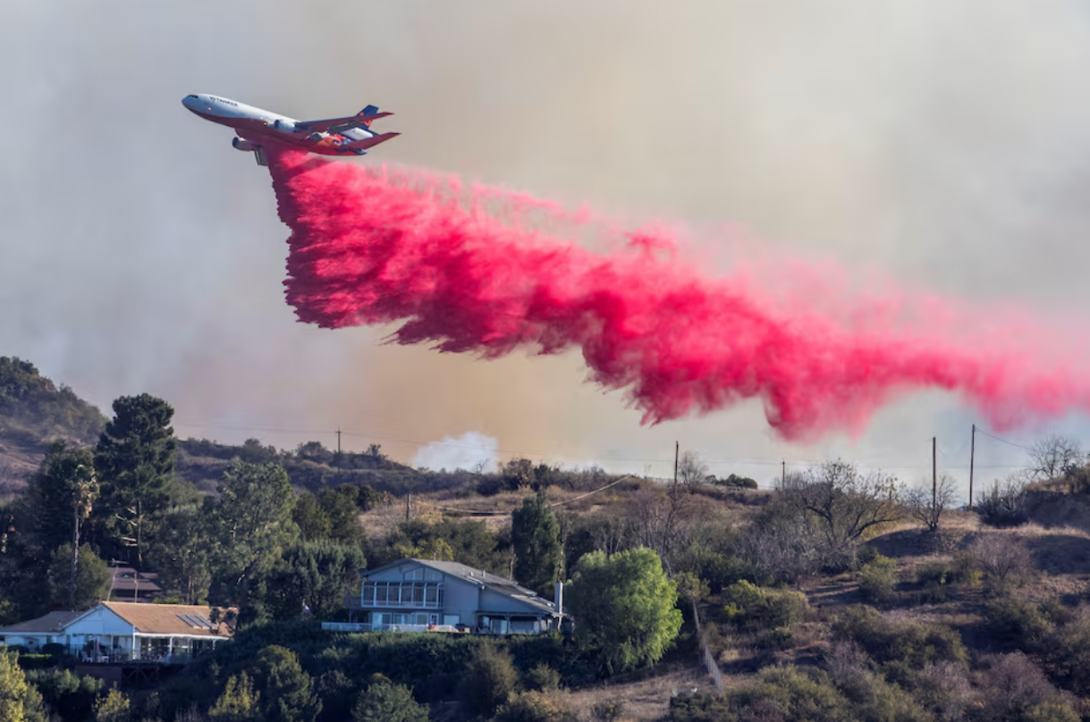 Aerial assault aims to stem LA Palisades fire eastward spread