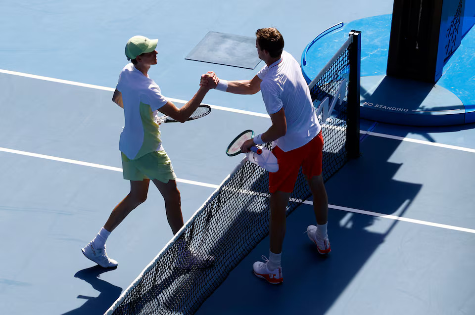 [2/5]Tennis - Australian Open - Melbourne Park, Melbourne, Australia - January 13, 2025 Italy's Jannik Sinner shakes hands with Chile's Nicolas Jarry after winning his first round match. Photo: Reuters