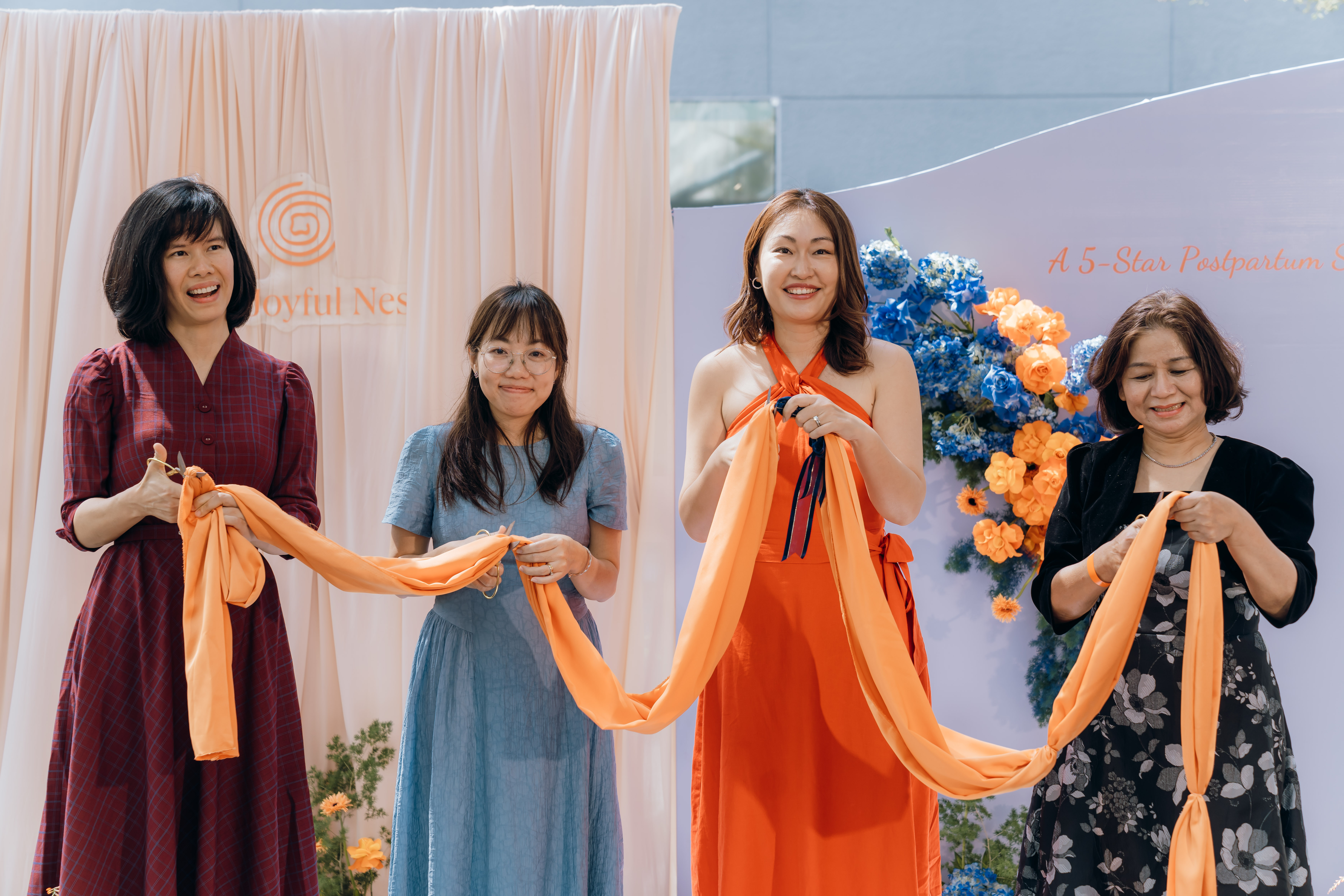 The ribbon-cutting ceremony for The Joyful Nest inauguration on January 11, 2025, featuring key founders and partners. From left to right: Dr. Duong Vu, Vietnam portfolio manager at FHI 360 Global Nutrition - East Asia Pacific technical specialist; Ruby Ngoc Nguyen, co-founder of The Joyful Nest; Kun Jiang, founder of The Joyful Nest; and Dr. Kieu Trinh, former head of the obstetrics ward at Quang Nam General Hospital in Quang Nam Province, central Vietnam