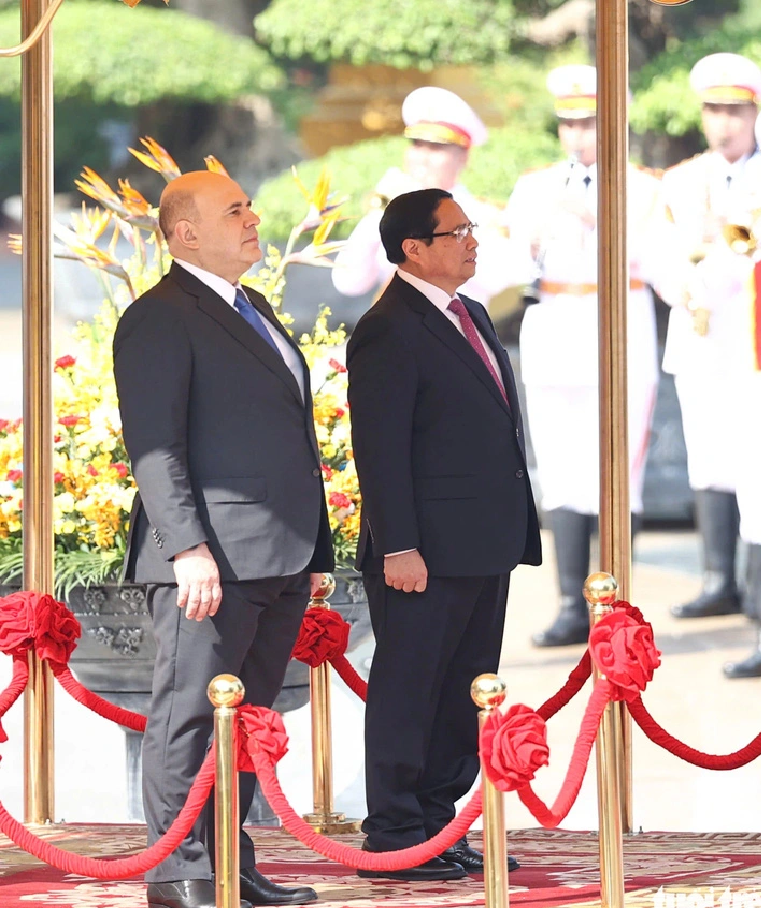 Vietnamese Prime Minister Pham Minh Chinh (R) and his Russian counterpart Mikhail Vladimirovich Mishustin stand on the platform of honor in Hanoi, January 14, 2025. Photo: Nguyen Khanh / Tuoi Tre