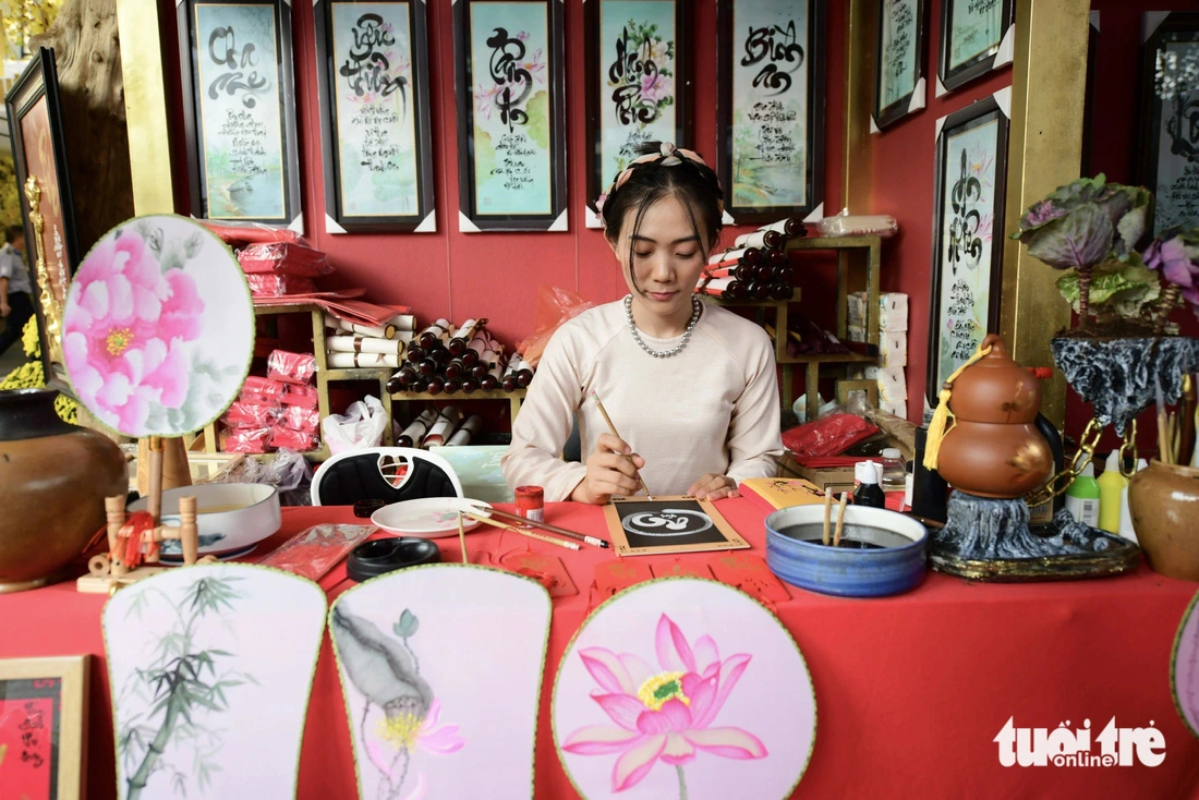 A young calligrapher writes calligraphy at the 2025 Vietnamese Tet Festival at the Youth Culture House in Ho Chi Minh City, January 13, 2024.