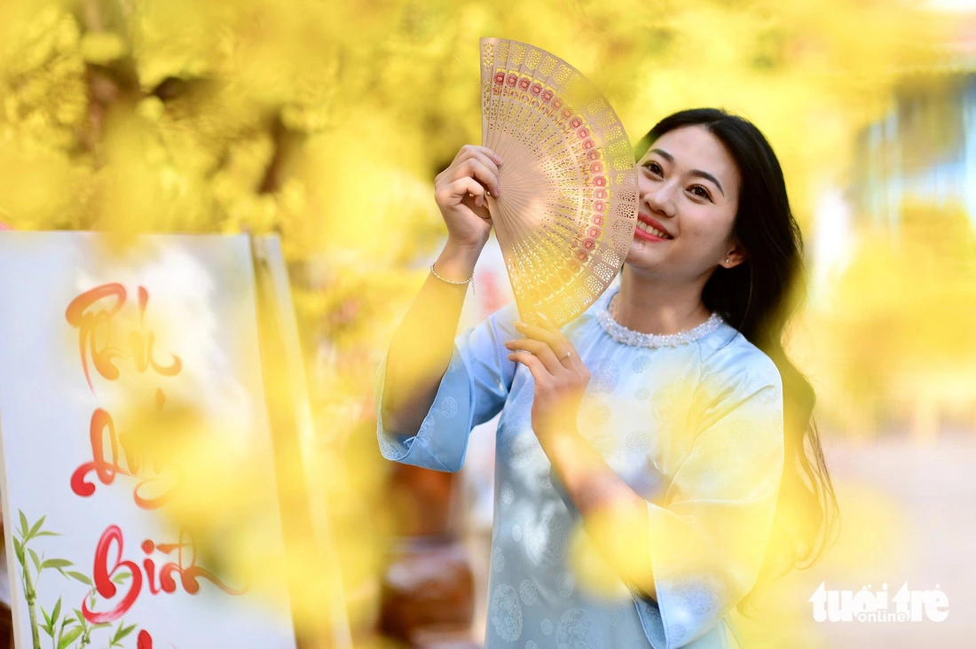 A woman poses for a photo at the 2025 Vietnamese Tet Festival at the Youth Culture House in Ho Chi Minh City, January 13, 2024.