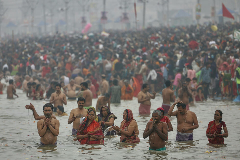 Hindu pilgrims take a dip in the sacred waters of Sangam, the confluence of Ganges, Yamuna and mythical Saraswati rivers during the Maha Kumbh Mela festival in Prayagraj on January 13, 2025. Photo: AFP