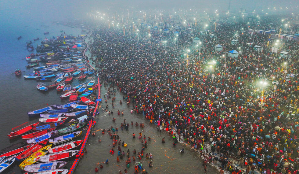 Hindu pilgrims gather to take a holy dip near the banks of Sangam, the confluence of Ganges, Yamuna and mythical Saraswati rivers, during Shahi Snan or 'royal bath', to mark the Maha Kumbh Mela festival, in Prayagraj on January 14, 2025. Photo: AFP