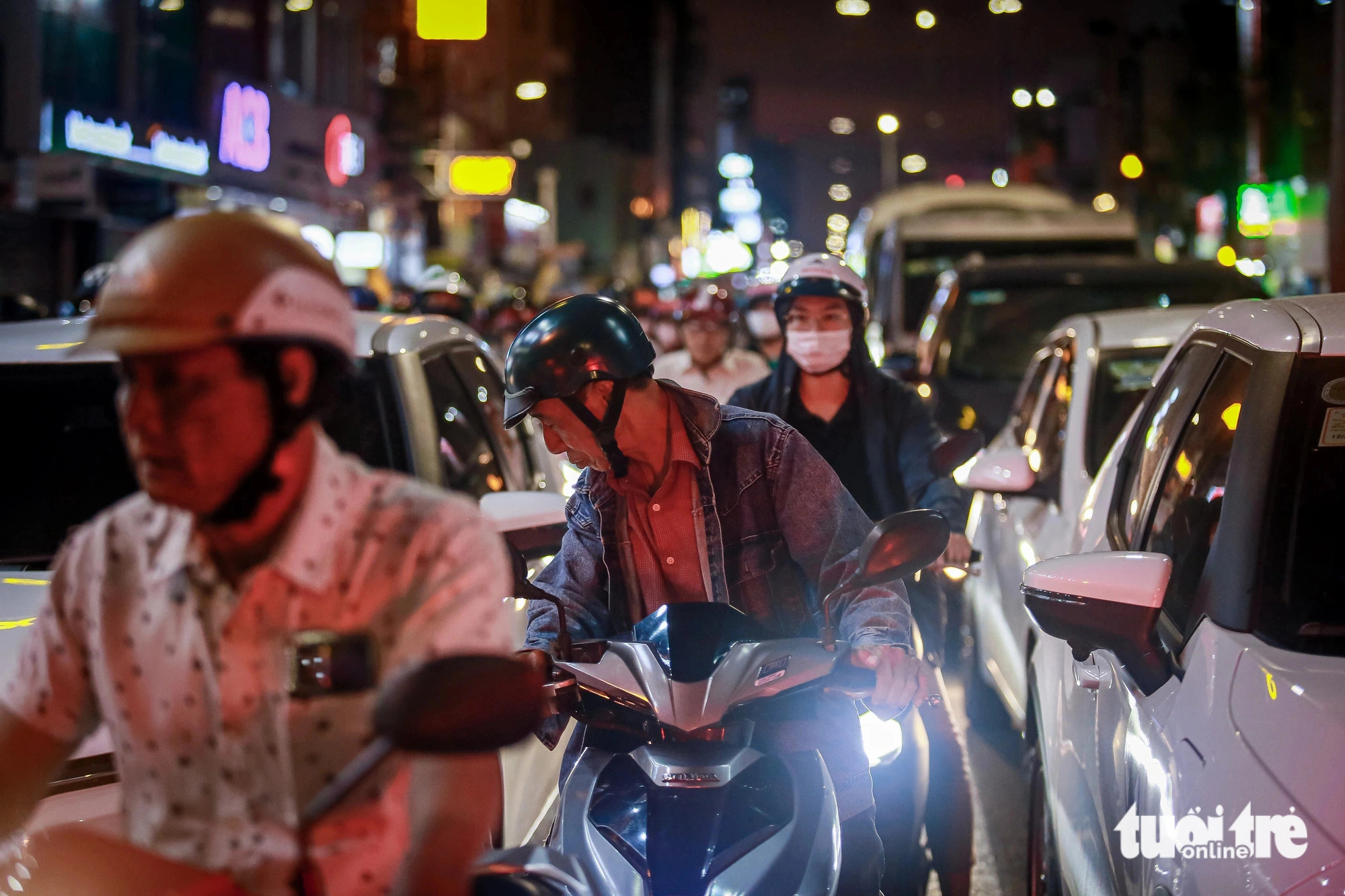 Motorcycles weave through gaps in the gridlock. Photo: Le Phan / Tuoi Tre