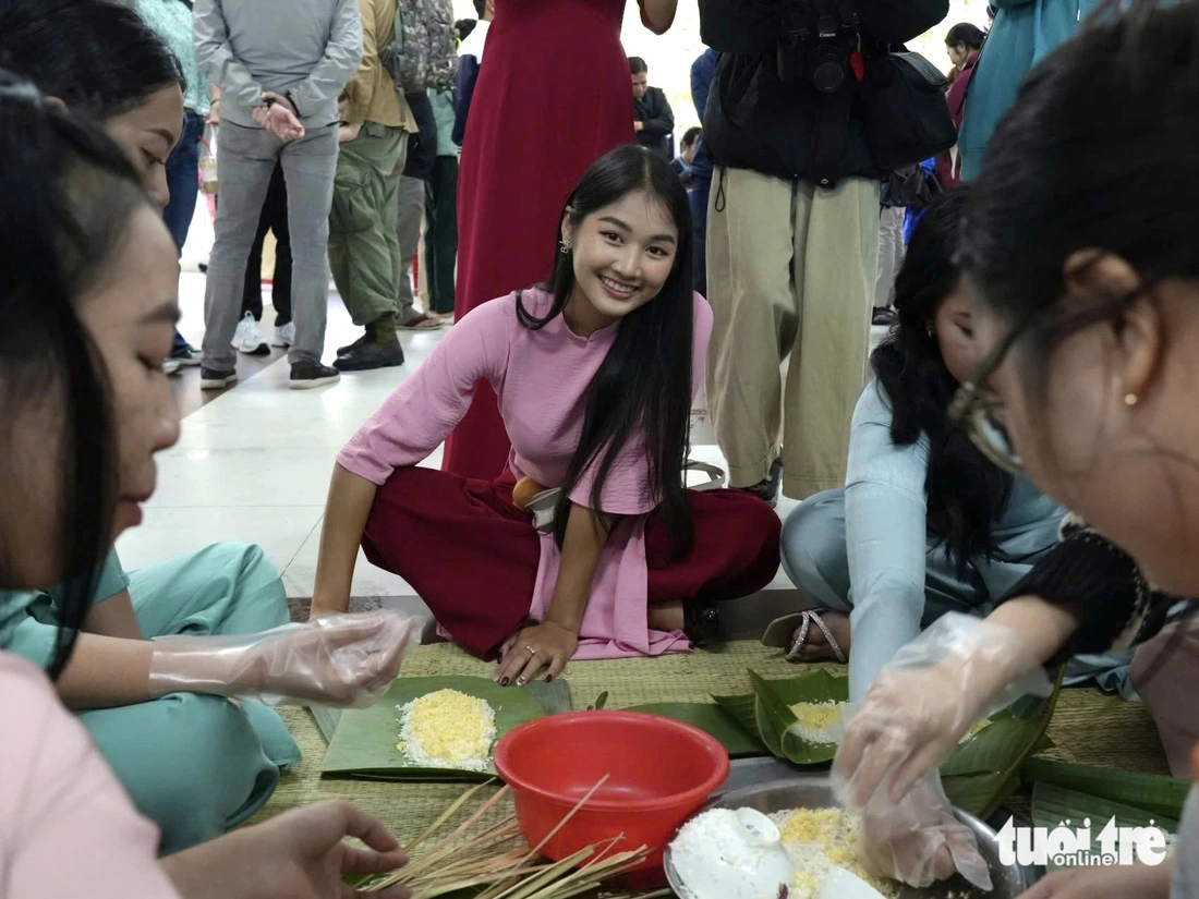 Muki (in a pink ao dai), from Thailand, learn to wrap ‘banh chung’.