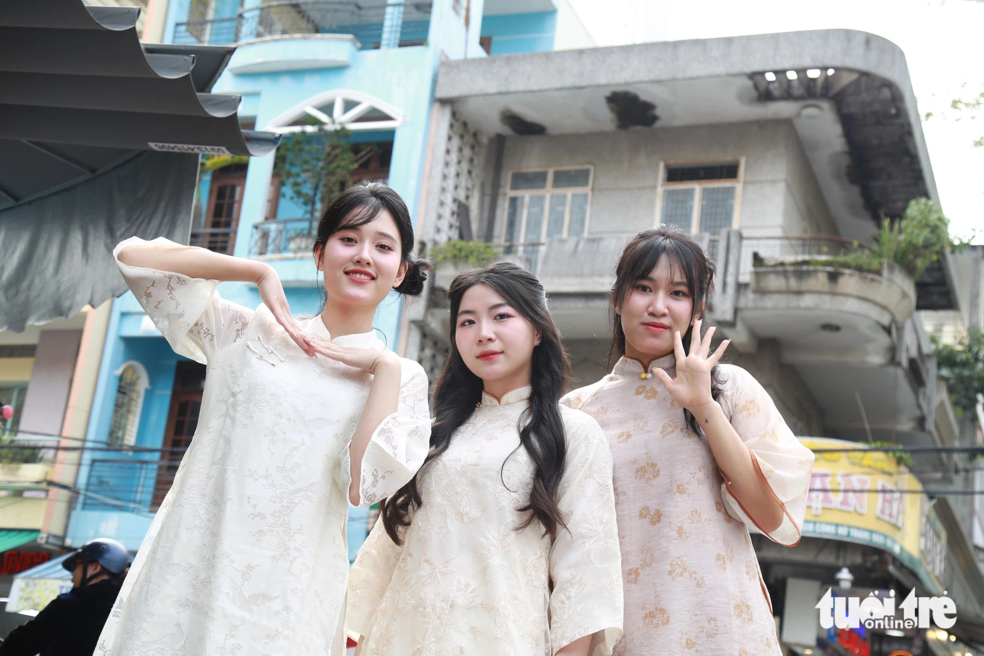 Three young women pose for a Tet-themed photo at Han Market in Da Nang City, central Vietnam. Photo: Doan Nhan / Tuoi Tre