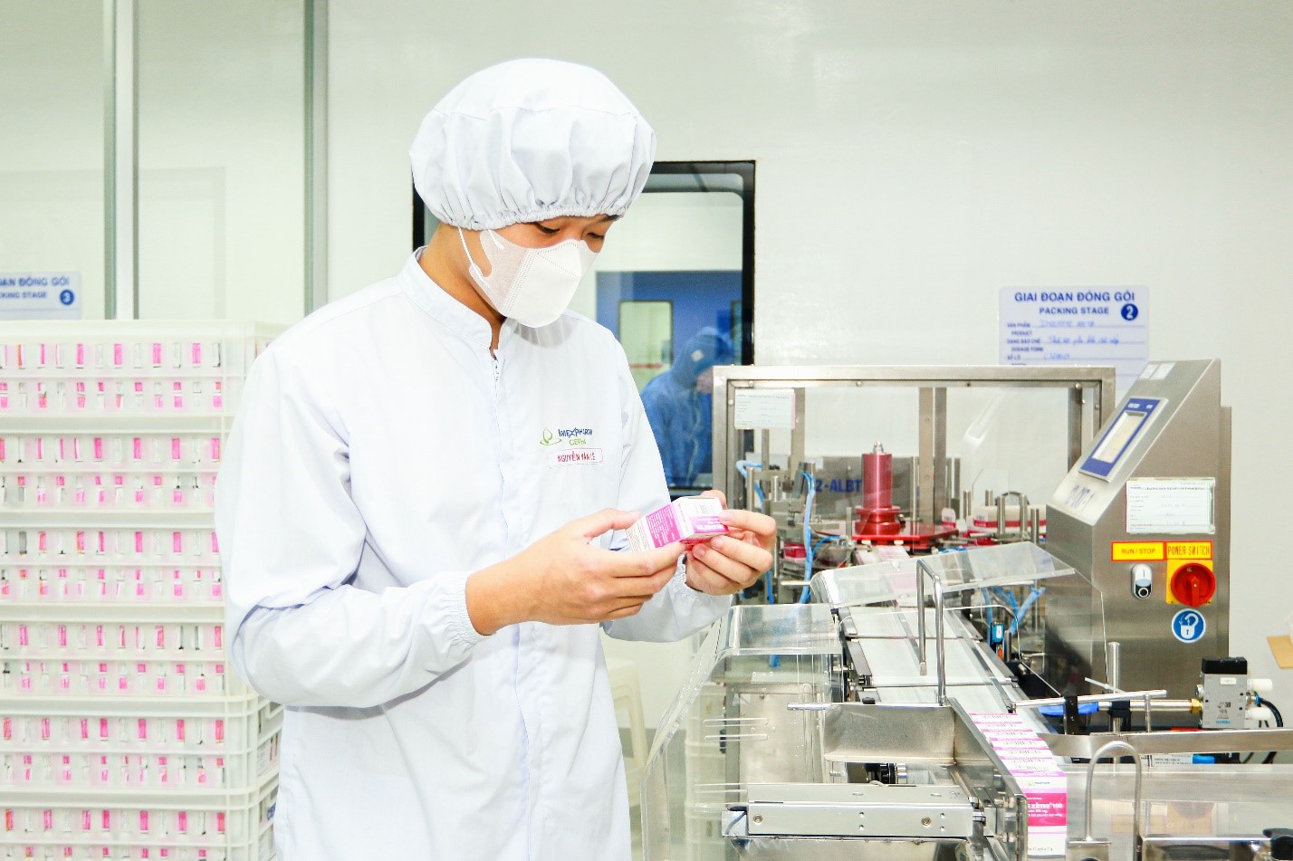 A staff inspects finished products during packaging at IMP4 factory. Photo: Imexpharm