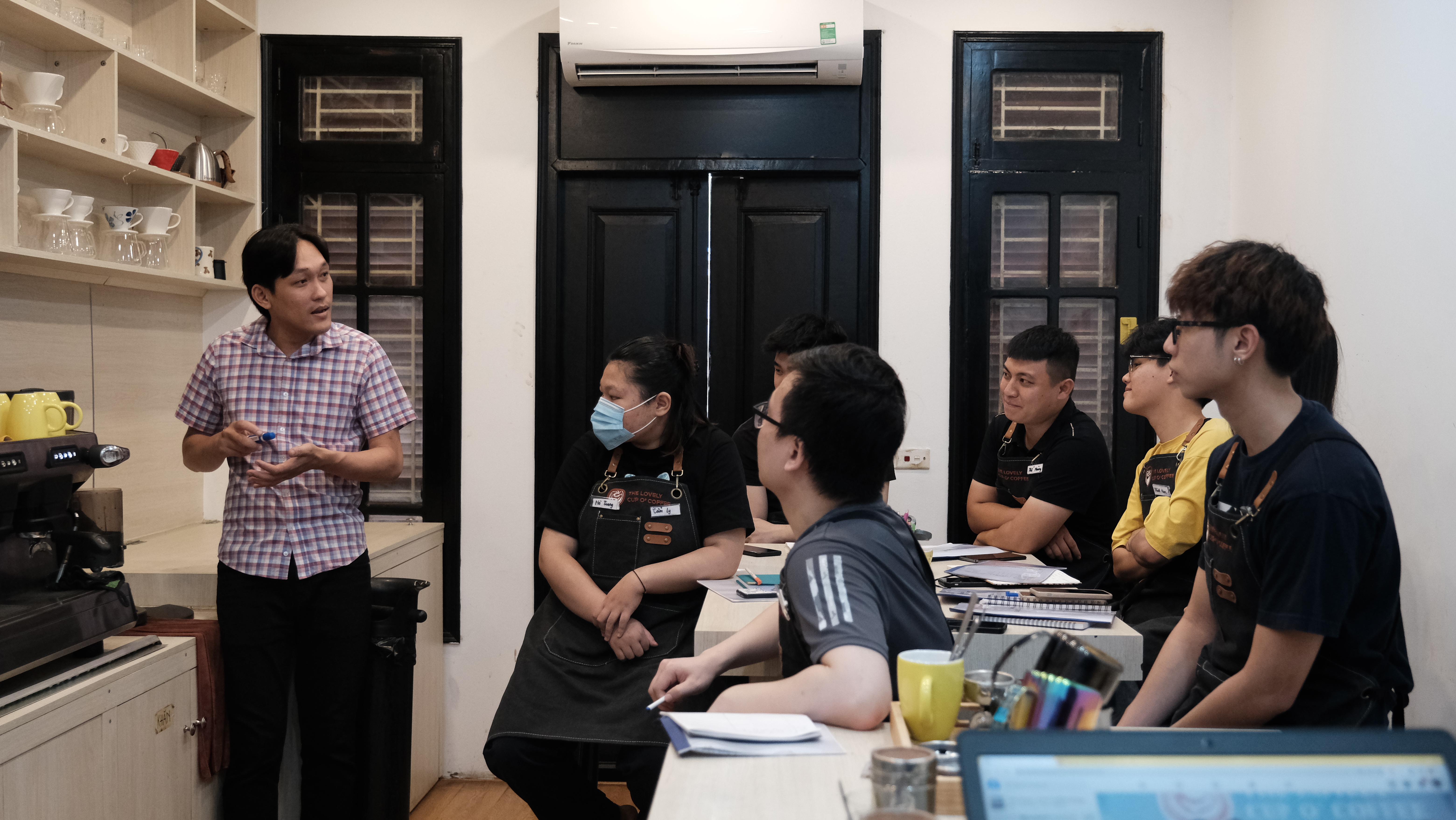 Dang The Lan (left) shares insights with barista trainees at The Lovely Cup O' Coffee. Photo: Supplied