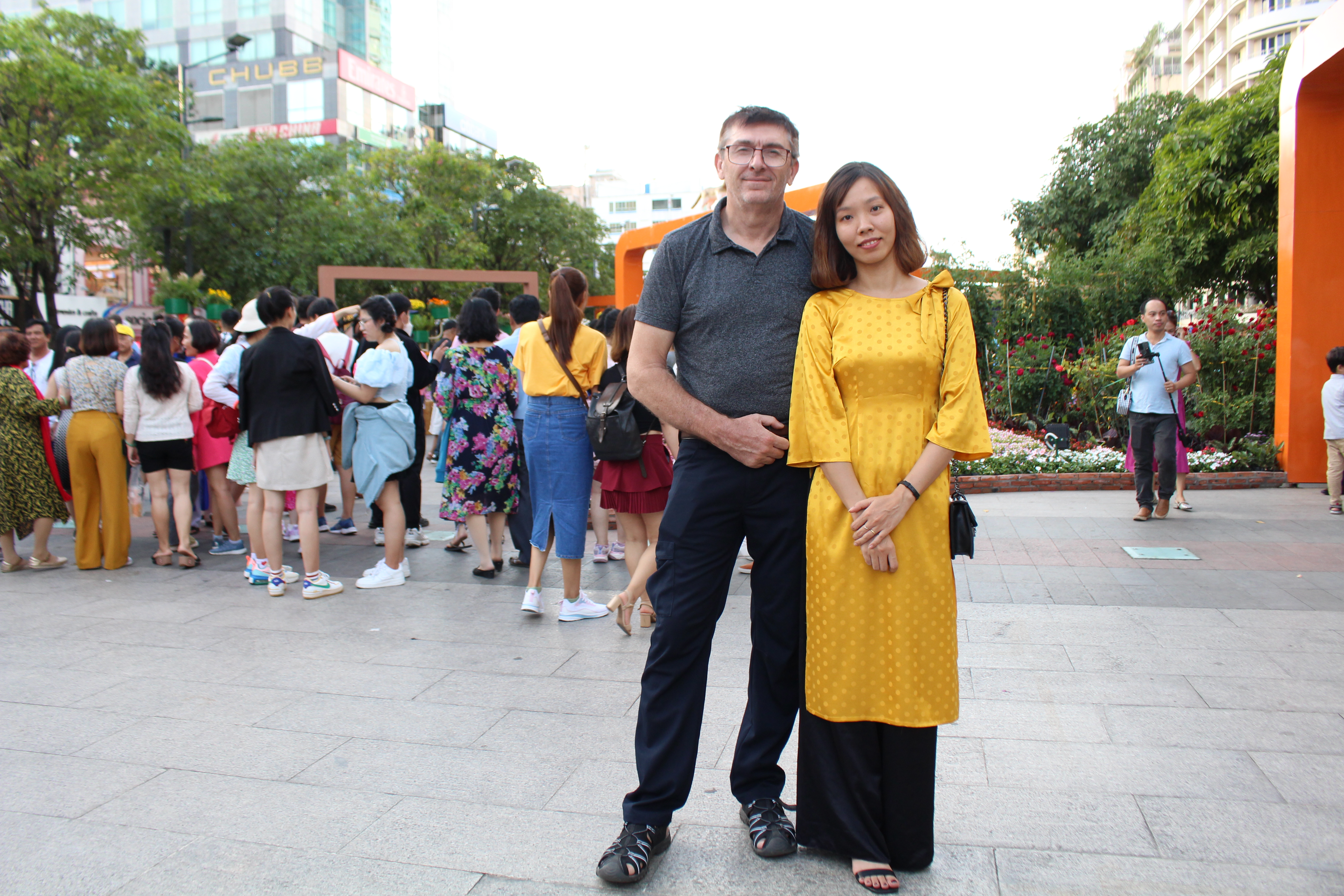 Ray Kuschert and his wife, Vu Thi Loan, pose for a photo while visiting Nguyen Hue Flower Street during Tet holiday. Photo: Supplied