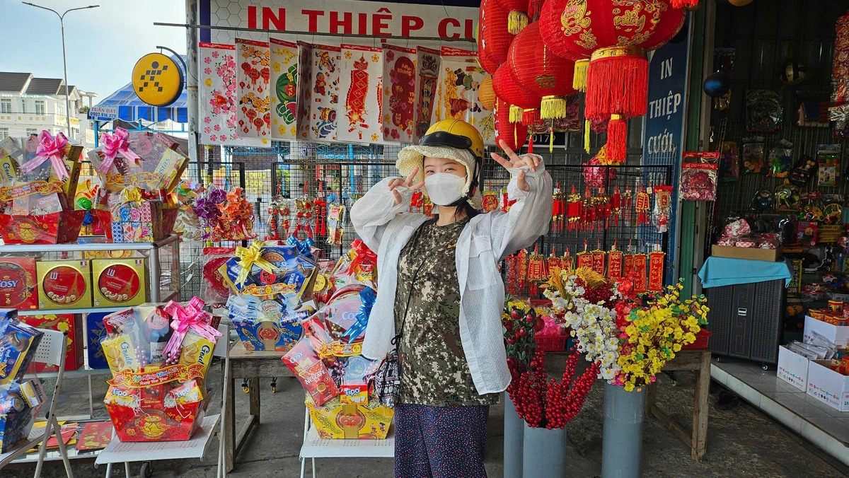 Hong Ha Young, a South Korean volunteer lecturer in Ho Chi Minh City, poses for a photo at a shop selling Tet items in Vietnam. Photo: Supplied