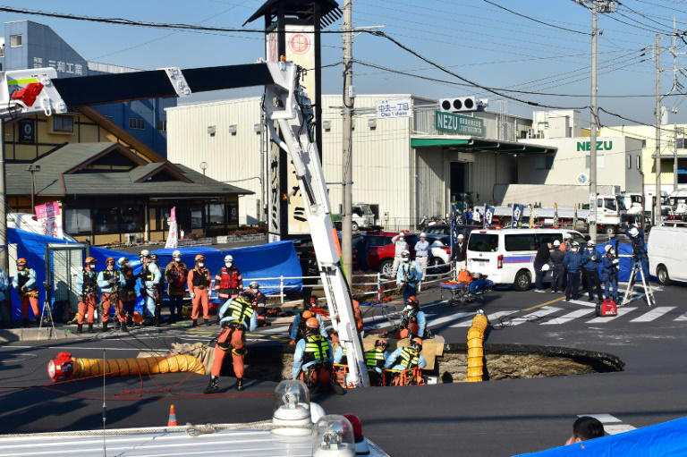 Japan trucker still stuck in sinkhole after 24 hours