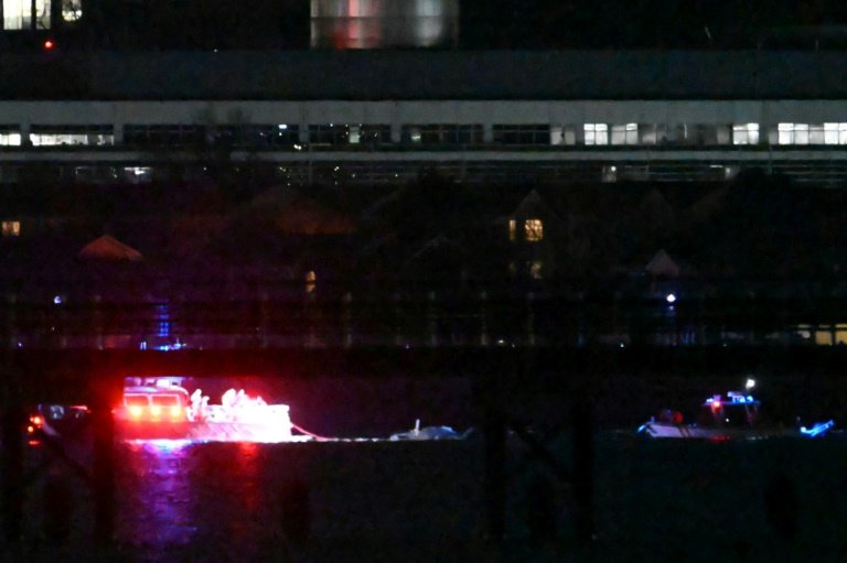 Two rescue boats pull debris from the water after a US passenger jet and a military helicopter crashed over the Potomac River near Reagan National Airport in Washington. Photo: AFP