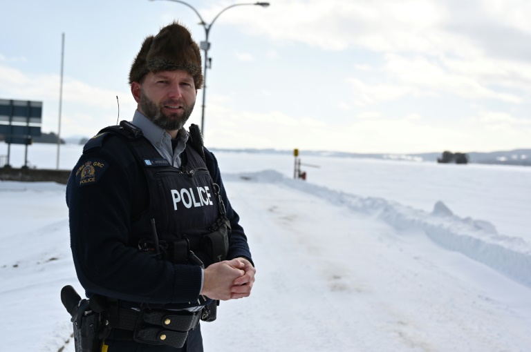 Royal Canadian Mounted Police Corporal Keven Rouleau stands next to Memphremagog Lake at the Canada-US, where he says illegal crossings take place over the frozen lake during winter, near the border town of Stanstead, Quebec, Canada, on January 30, 2025. Photo: AFP