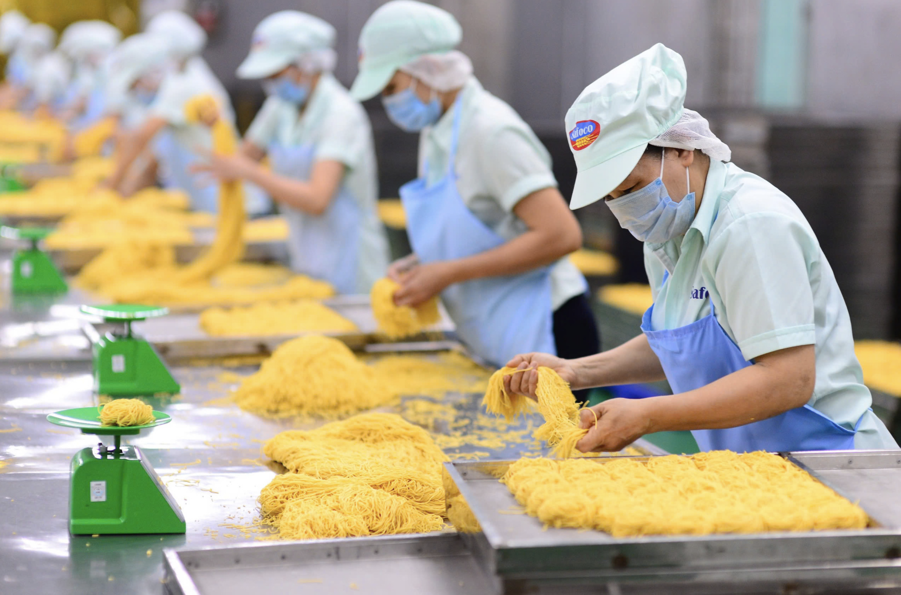 Employees package instant noodles at a food company in Ho Chi Minh City for export. Photo: Quang Dinh / Tuoi Tre