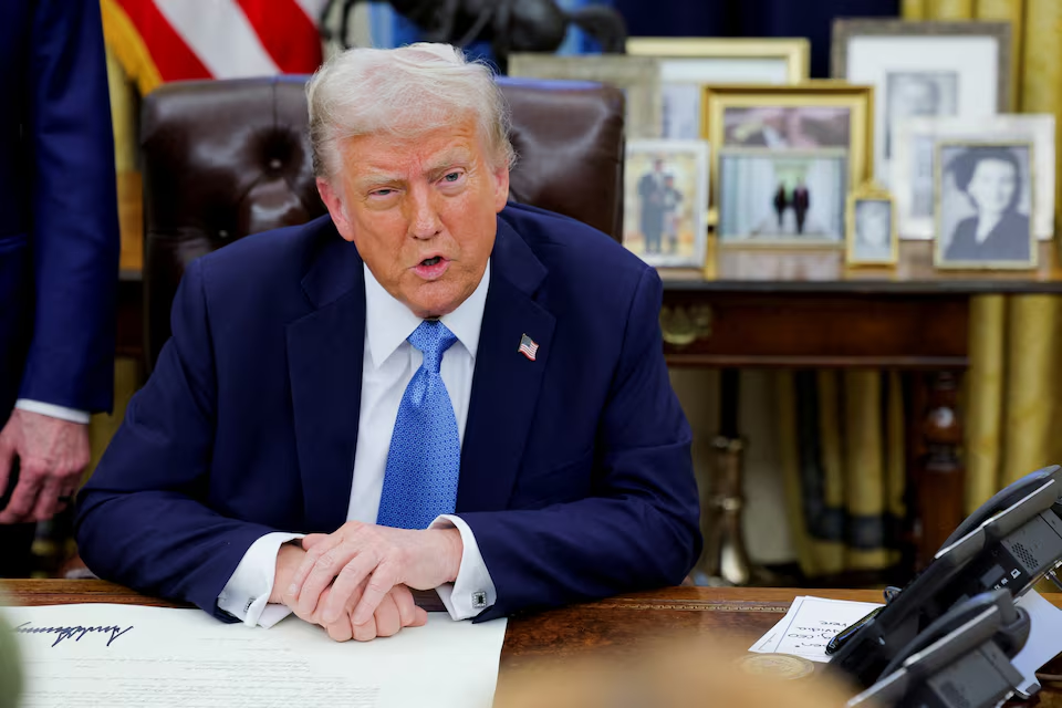 U.S. President Donald Trump looks on as he signs an executive order in the Oval Office at the White House in Washington, U.S., January 31, 2025. Photo: Reuters