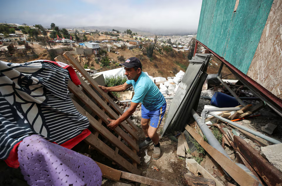 [2/6]Carlos Vidal works to rebuild his house after it was destroyed by wildfires, in the neighborhood of Villa Independencia in Vina del Mar, Chile February 1, 2025. Photo: Reuters