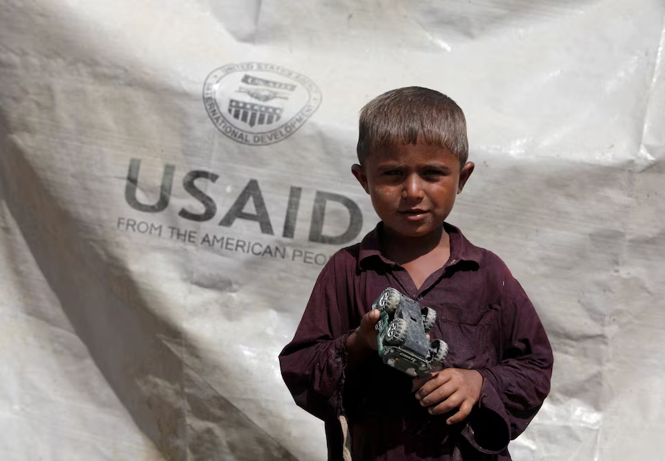 Sajad, 7, who has been displaced by flooding, holds his toy jeep outside his family tent with the weather sheet donated by USAID, while taking refuge on an embankment near Kari Mori, some 32 km (20 miles) from Dadu, in Pakistan's Sindh province October 5, 2010. Photo: Reuters