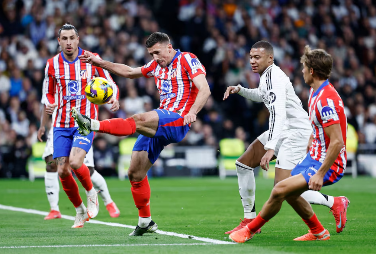 Soccer Football - LaLiga - Real Madrid v Atletico Madrid - Santiago Bernabeu, Madrid, Spain - February 8, 2025 Atletico Madrid's Clement Lenglet in action with Real Madrid's Kylian Mbappe. Photo: Reuters