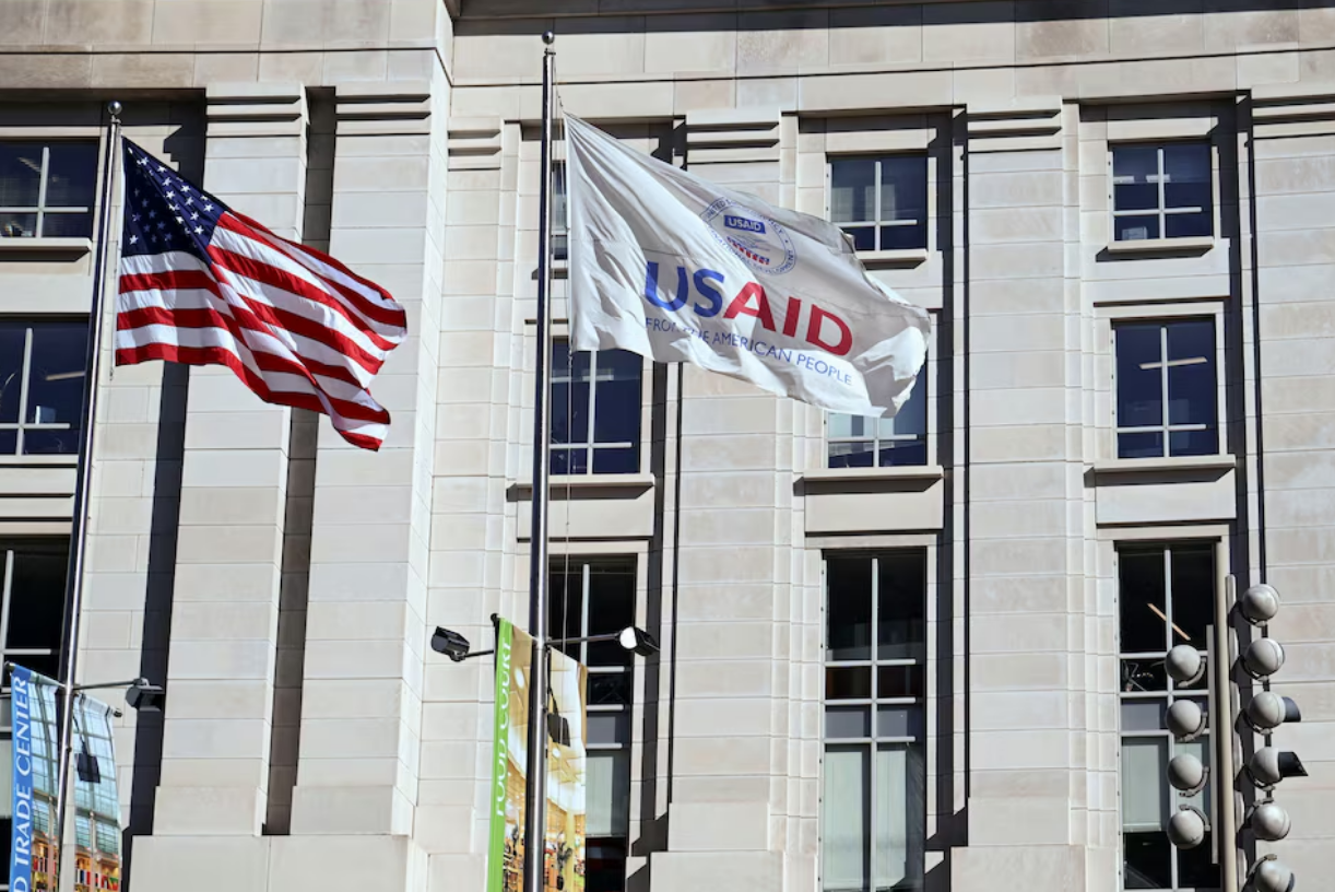 An American flag and USAID flag fly outside the USAID building in Washington, D.C., U.S., February 1, 2025. Photo: Reuters