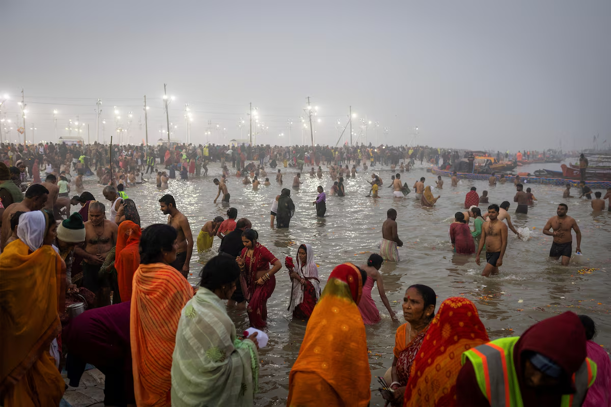 Devotees take a holy dip at Sangam, the confluence of the Ganges and Yamuna rivers with the mythical, invisible Saraswati river, during the 'Maha Kumbh Mela', or the Great Pitcher Festival, in Prayagraj, India, January 13, 2025. Photo: Reuters