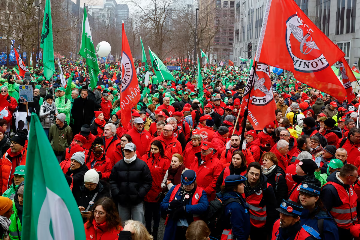 Workers and members of trade unions hold flags during a national strike demanding stronger public services in Brussels, Belgium February 13, 2025. Photo: Reuters