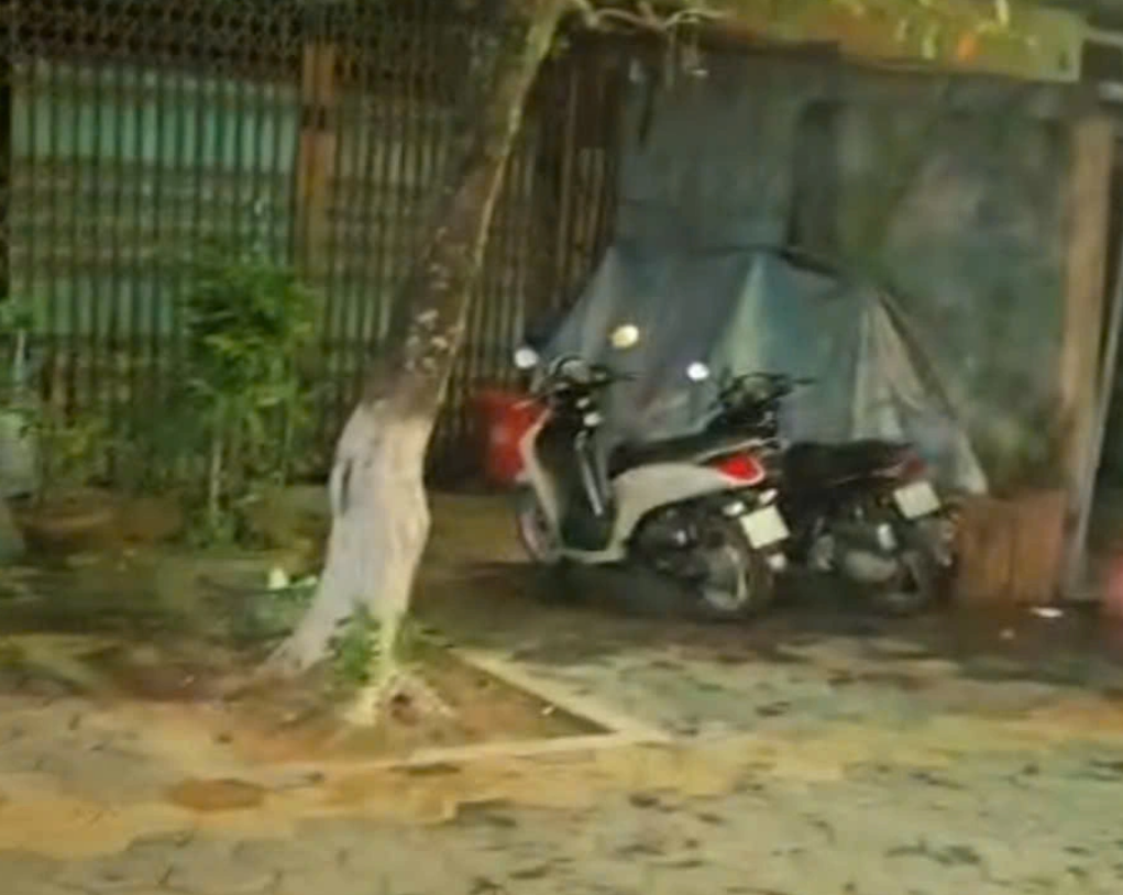 A still image taken from a video shows two motorcycles left on a sidewalk in Quang Ngai Province, central Vietnam by two Turkish tourists.