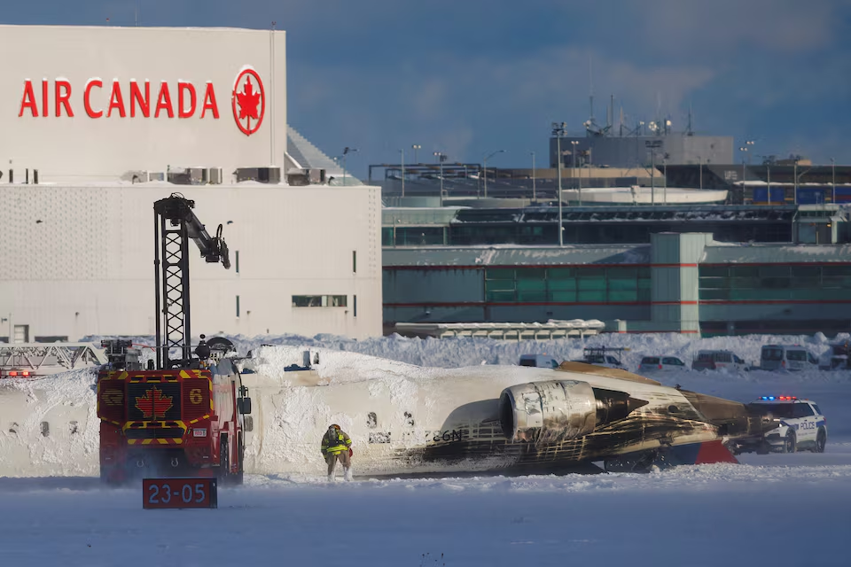 An emergency responder works around an aircraft on a runway, after a plane crash at Toronto Pearson International Airport in Mississauga, Ontario, Canada February 17, 2025. Photo: Reuters