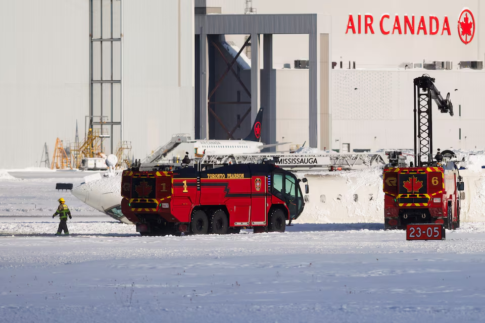 An emergency responder works near an aircraft on a runway, after a plane crash at Toronto Pearson International Airport in Mississauga, Ontario, Canada February 17, 2025. Photo: Reuters