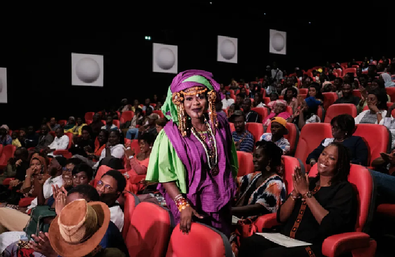 Sokhna Ndeye Merry Sall (C), a student in biology, chemistry and geosciences, walks to collect a prize for her film project during the Ceremonie de Cloture et Remise D'Attestations du Programme Afric'art Opportunity in Dakar. Photo: AFP