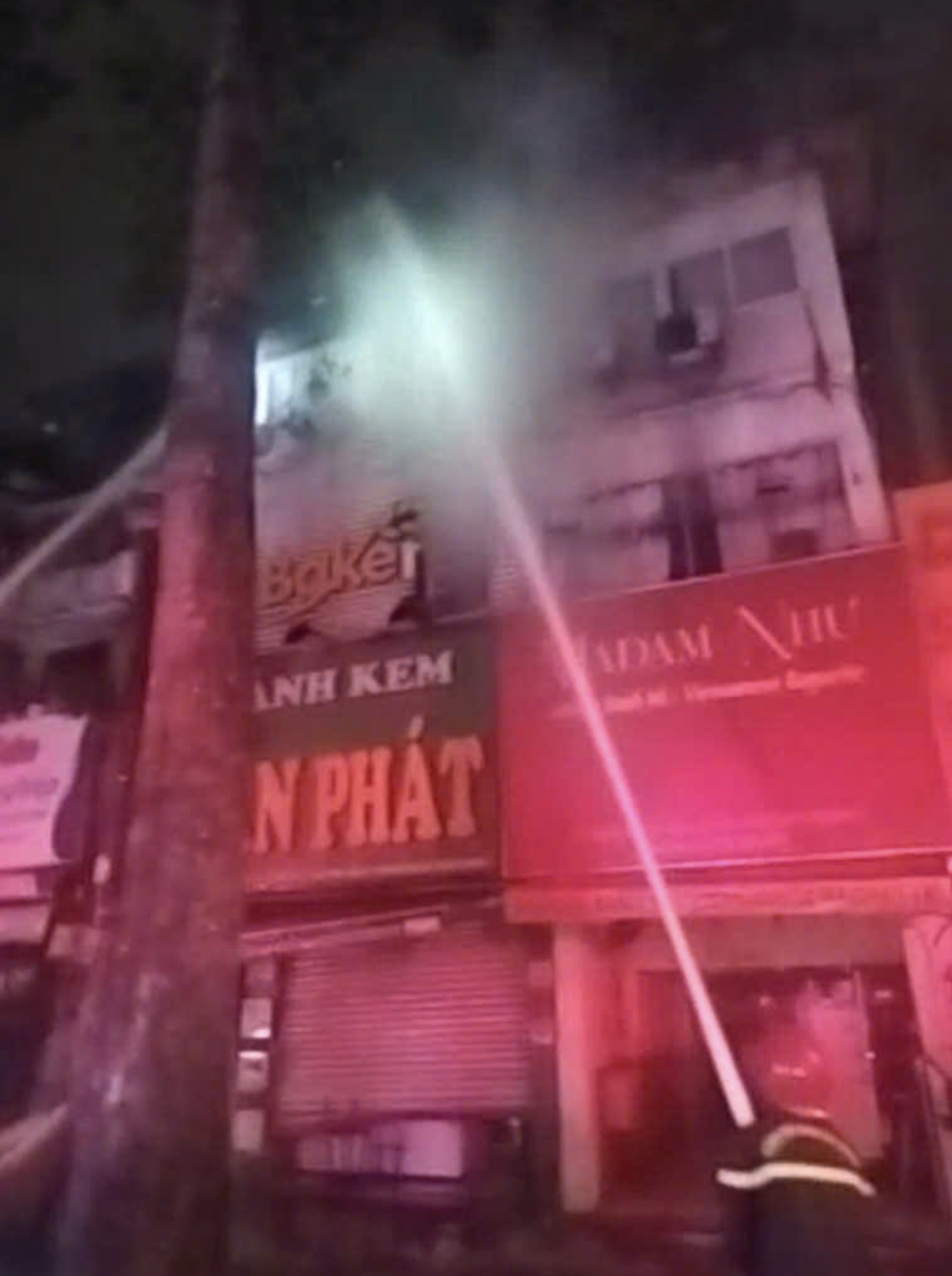 Firefighters spray water to extinguish flames at a bakery in downtown Ho Chi Minh City on February 24, 2025. Photo: Supplied