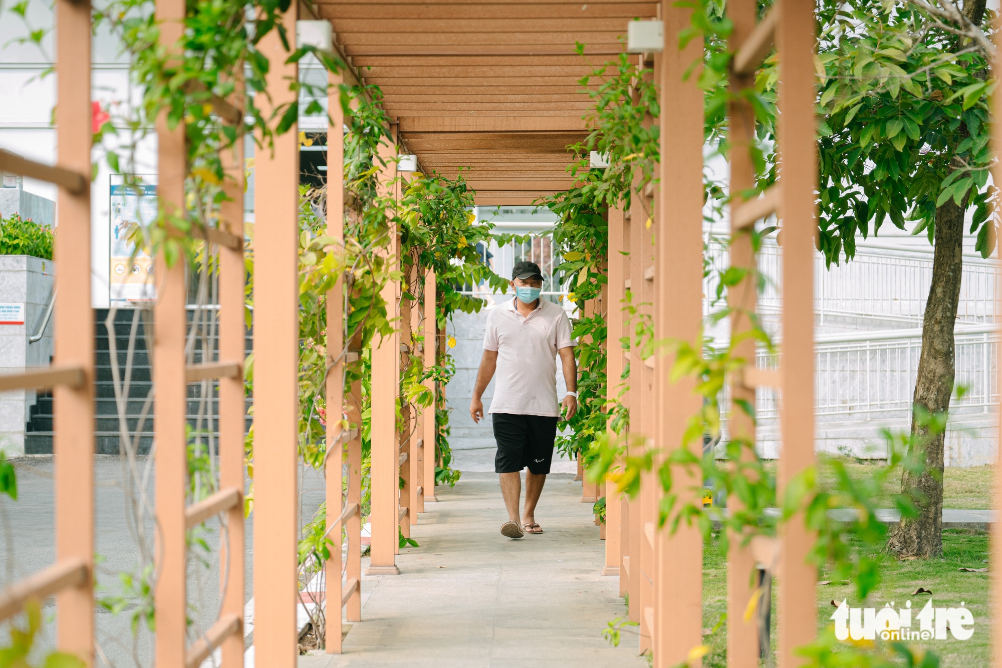 A man walks under a shaded walkway at the Blood Transfusion and Hematology Hospital at the Tan Kien medical campus in Tan Kien Commune, Binh Chanh District, Ho Chi Minh City. Photo: Thanh Hiep / Tuoi Tre