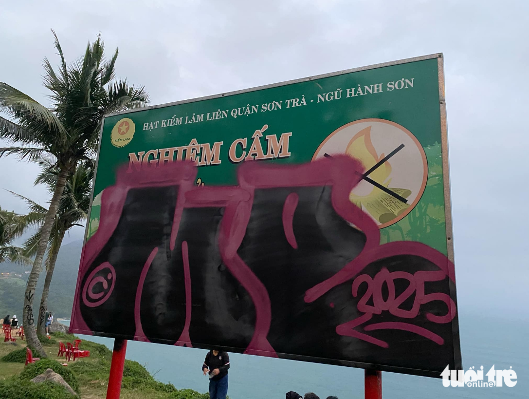 A sign on Son Tra Peninsula in Da Nang City, central Vietnam is vandalized with graffiti. Photo: Kim Tuyet / Tuoi Tre