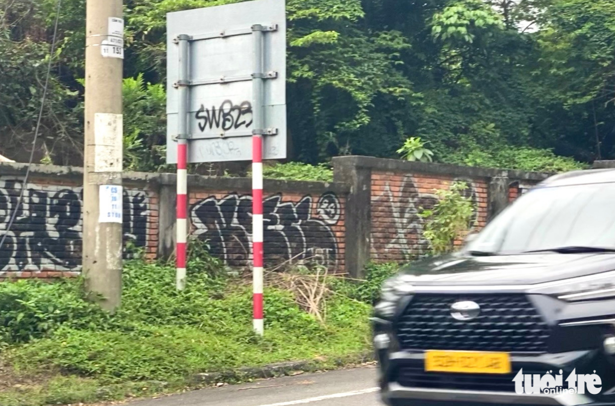 A wall along a road on Son Tra Peninsula in Da Nang City is covered with graffiti.