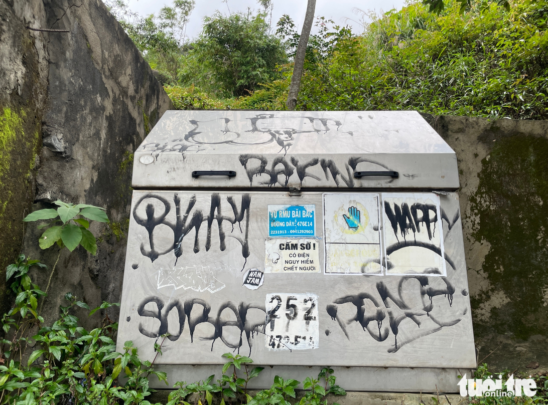 An electrical cabinet is smeared with graffiti.