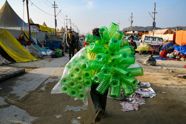 A vendor sells plastic bottles used by pilgrims to carry holy water during the Kumbh Mela festival in Prayagraj on February 25, 2025. Photo: AFP