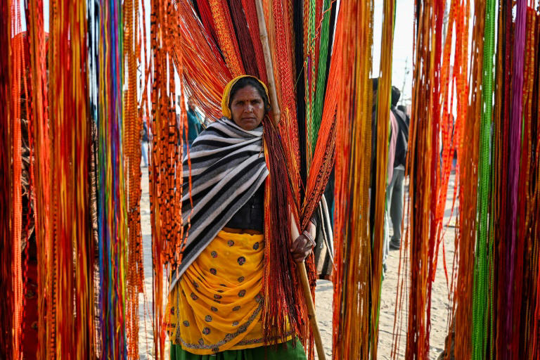 A woman sells religious threads during the Kumbh Mela festival in Prayagraj on February 25, 2025. Photo: AFP