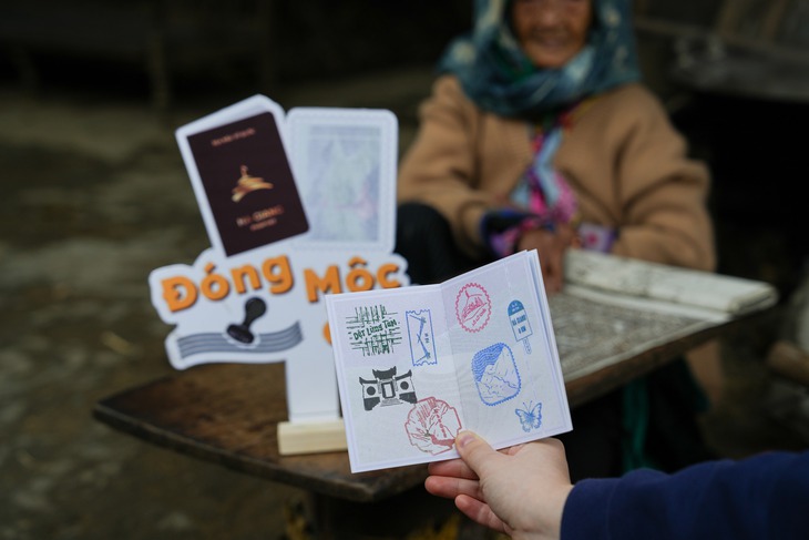 A tourist shows the ‘Ha Giang Passport’ at Lung Tam weaving village in Quan Ba District, Ha Giang Province, northern Vietnam. Photo: Supplied