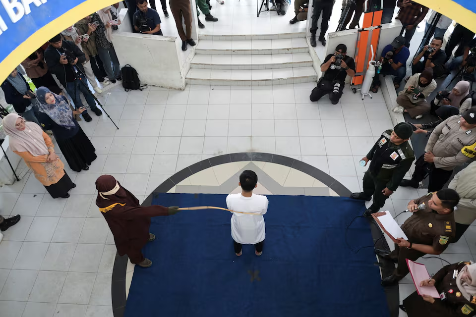 A man convicted of having same sex relationship is publicly caned by a Sharia Law official in Banda Aceh, Indonesia, February 27, 2025. Photo: Reuters