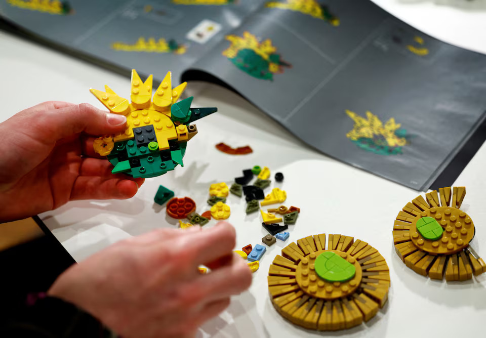 [4/15]LEGO Product Designer Stijn Oom puts bricks together to assemble a LEGO brick version of Van Gogh's Sunflowers painting at Van Gogh Museum in Amsterdam, Netherlands February 28, 2025. Photo: Reuters