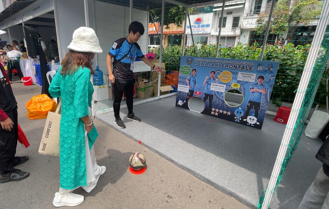 A visitor tries out football at a sports booth at the 10th Japan Vietnam Festival in Ho Chi Minh City on March 8, 2025. Photo: Dong Nguyen / Tuoi Tre News